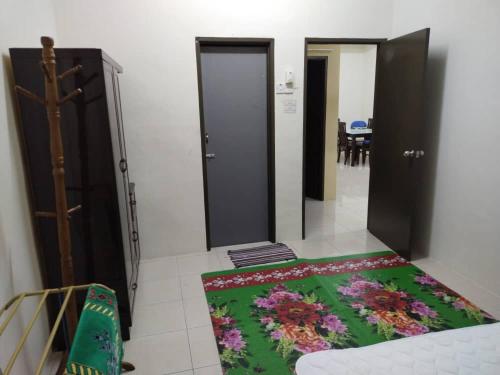 a room with two doors and a rug on the floor at Permai Homestay in Baling