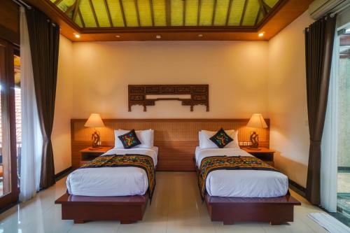Cama ou camas em um quarto em Giri Bhagawan Villas & Spa