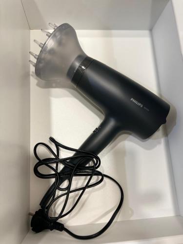 a blow dryer on a white table with a cord at Prisma Apartment in Tallinn