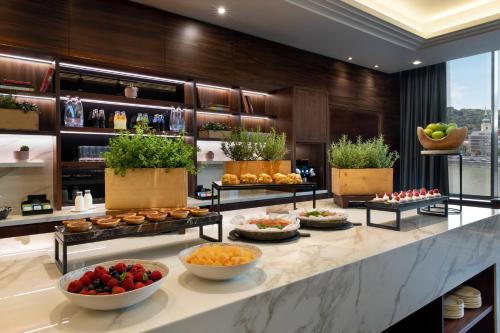 a buffet line with fruits and vegetables in a hotel lobby at Budapest Marriott Hotel in Budapest