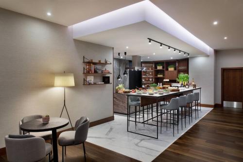 a kitchen and dining room with a table and chairs at Budapest Marriott Hotel in Budapest