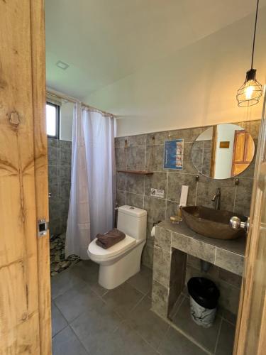 a bathroom with a toilet and a sink at Hutch Lodging House in El Nido