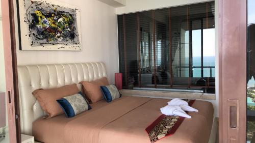 a living room with a couch and a window at Phupha Rayong by gift in Klaeng