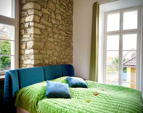 a bedroom with a blue bed with two pillows on it at Altstadt pur! An der schönen Katharinenkirche in Oppenheim