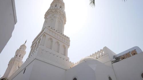 a white building with a clock tower on it at InterContinental Dar Al Hijra Madinah, an IHG Hotel in Al Madinah