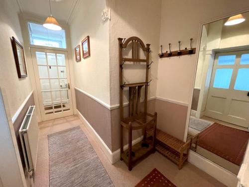a hallway with a room with a ladder and a door at Charming 3BR Flat in Beautiful Kirkcudbright in Kirkcudbright