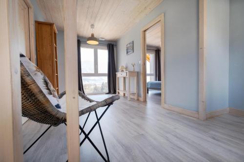 a room with a chair in the middle of a room at Le Gite de Noemie in Mercury