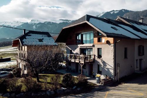a house with mountains in the background at Le Gite de Noemie in Mercury