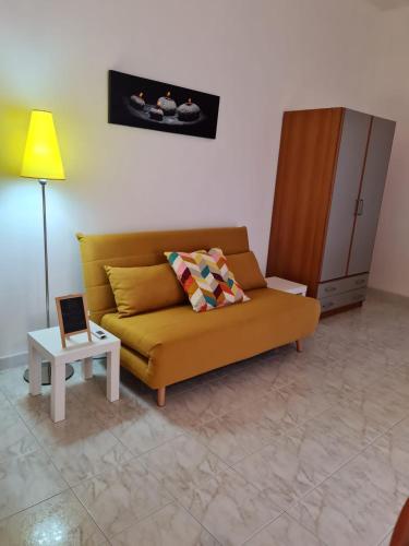 a living room with a couch and a table at Appartamenti MiNuMa Tropea in Tropea