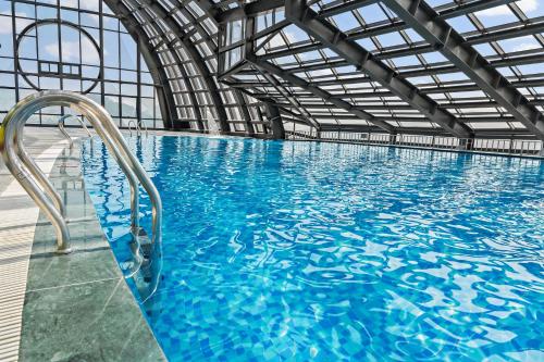 a large indoor swimming pool with blue water at Muong Thanh Luxury Cao Bang in Cao Bằng