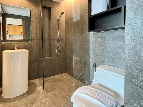 a bathroom with a shower and a toilet at Kamala Beach Pool view Resort P15 in Kamala Beach