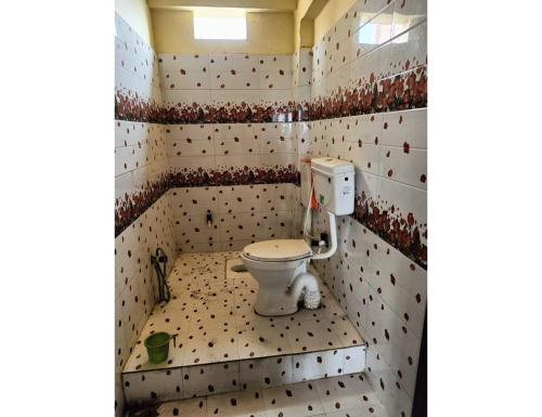 a bathroom with a toilet in a small room at Hotel Vinayak Vihar, Sasaram in Ara
