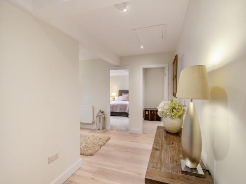 a living room with a table with a lamp and a bed at Market Square in Grassington