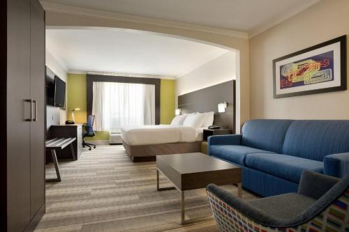 a hotel room with a bed and a couch at Holiday Inn Express Hotel & Suites Dallas NE - Allen, an IHG Hotel in Allen