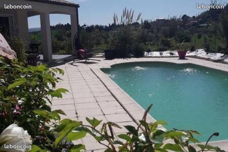 una gran piscina en un patio con una casa en Villa Jade en Lasserre-de-Prouille