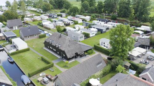an aerial view of a village with a large house at De Sloothaak in Giethoorn