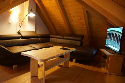 a living room with a couch and a coffee table at Bioferienhof Brückler in Laussa