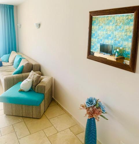 a living room with a couch and a mirror at Royal Apartment Sea view by Kaliakria in Topola