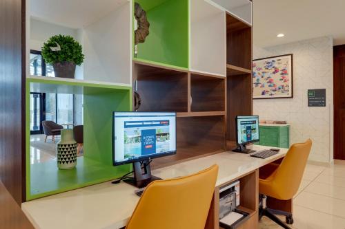 two computer monitors sitting on a desk in an office at Holiday Inn Mobile Airport by IHG in Mobile