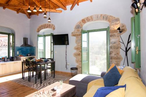 a living room with a couch and a table at Stavroulas Stone House in Rigklia, Messinia in Riglia