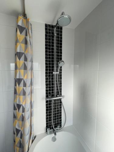 a shower in a bathroom with a shower curtain at St Martins Holiday Home Contractors Welcome in Thorngumbald