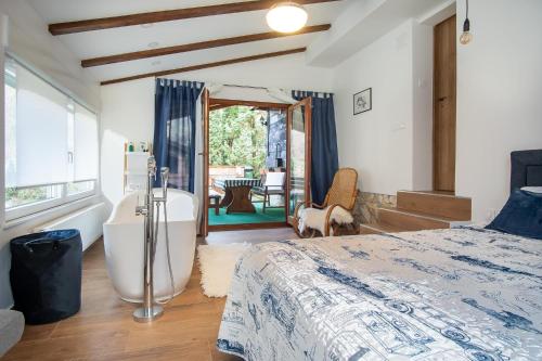 sypialnia z wanną i łóżkiem w obiekcie Cabin In The Woods Vukelic w mieście Stubicke Toplice