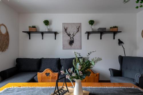 a living room with a couch and a table at Zemplén Gyöngye Vendégház in Erdőhorváti