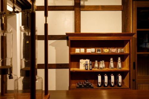 a display case with a bunch of alcohol bottles at Machi no Odoriba in Kanazawa
