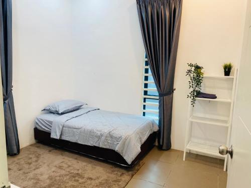 a small bedroom with a bed and a staircase at Homestay Alor Setar Nearby Hospital Sultanah Bahiyah in Alor Setar