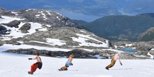 three people walking in the snow on a mountain at Odda View in Odda