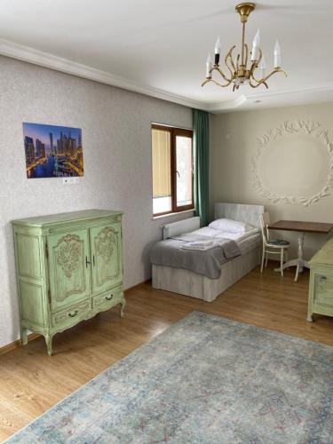 a bedroom with a bed and a dresser at ART HOUSE 33 in Kutaisi