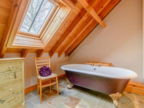 a large bath tub in a room with a window at Seaton Court - Uk31955 in Staithes