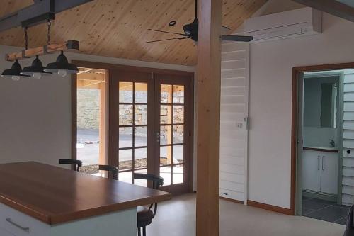 a kitchen and dining room with a wooden ceiling at The Dentist on Lava - 2 bathroom. 2 bedrooms in Warrnambool