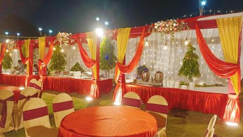 a set of tables with red and white curtains at The Kannelite in Jamshedpur
