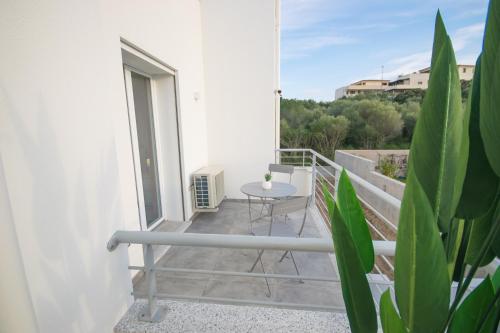 a balcony with a table and a table at Artemisia Home in Olbia