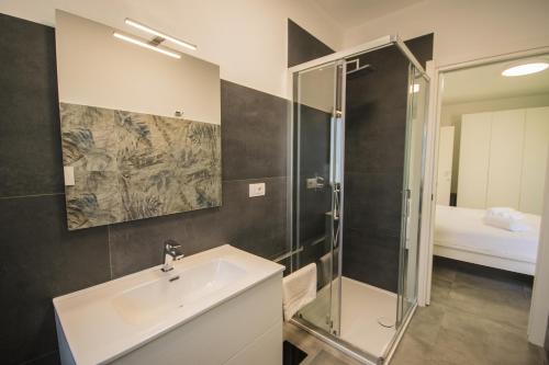 a bathroom with a sink and a shower at Artemisia Home in Olbia