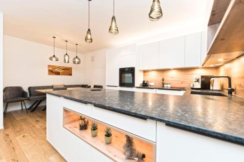a kitchen with white cabinets and a counter top at Bel`Laret in Samnaun