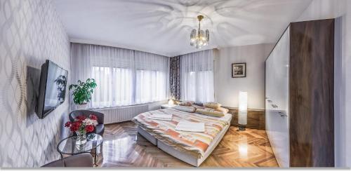a bedroom with a large bed in a room at Marika Apartmanok Zalakaros in Zalakaros