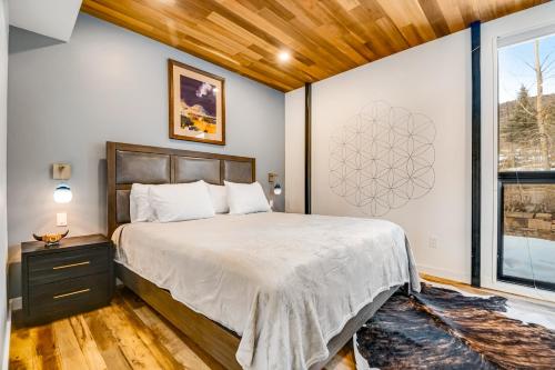 a bedroom with a large bed and a window at Tree Farm Sanctuary in Basalt