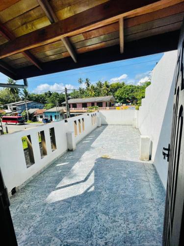 a view from a balcony of a white building at Lak Villa in Hikkaduwa
