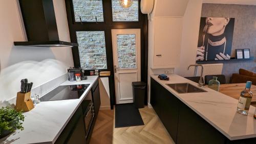 a kitchen with a sink and a counter top at Heiligeweg 48 in Harlingen