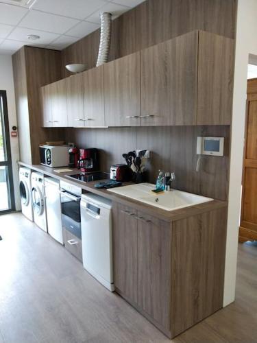a kitchen with a sink and a stove top oven at Appartement au Crotoy in Le Crotoy