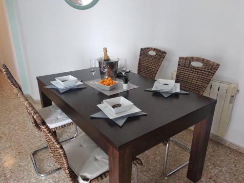 a table with two chairs and a bowl of food on it at Calpe Star in Calpe