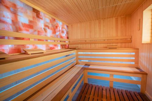 a wooden sauna with a wooden bench in it at Hotel Stein Collection in Timişoara