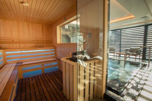 an inside of a sauna with a glass wall at Hotel Stein Collection in Timişoara