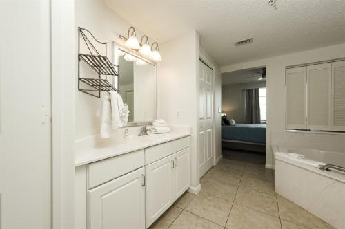 a bathroom with a sink and a mirror and a tub at Unit 2320 Ocean Walk - 2 Bedroom Ocean View in Daytona Beach