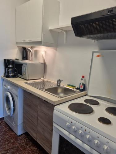 a kitchen with a stove and a sink at Panorama in Arachova