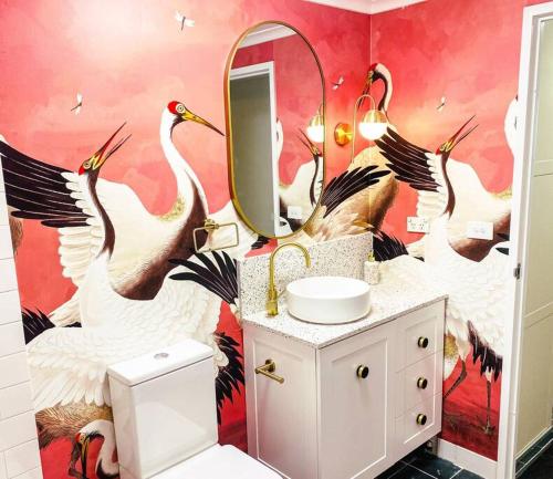 a bathroom with birds painted on the wall at Darling Harbour stunning city location with pool, gym, wifi, Netflix in Sydney