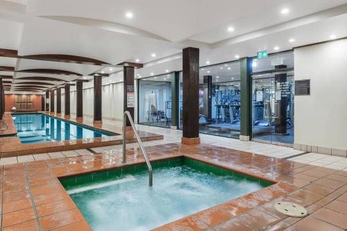 a large swimming pool in the middle of a building at Darling Harbour stunning city location with pool, gym, wifi, Netflix in Sydney