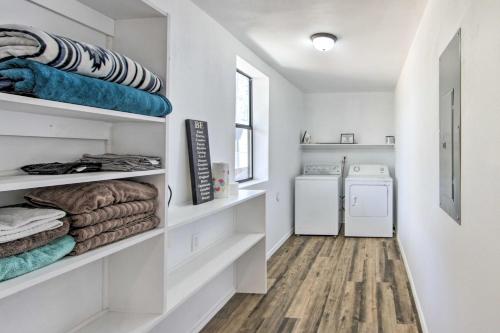 a laundry room with white shelves and a washer and dryer at Rural Gilmer House with Covered Patio! in Gilmer